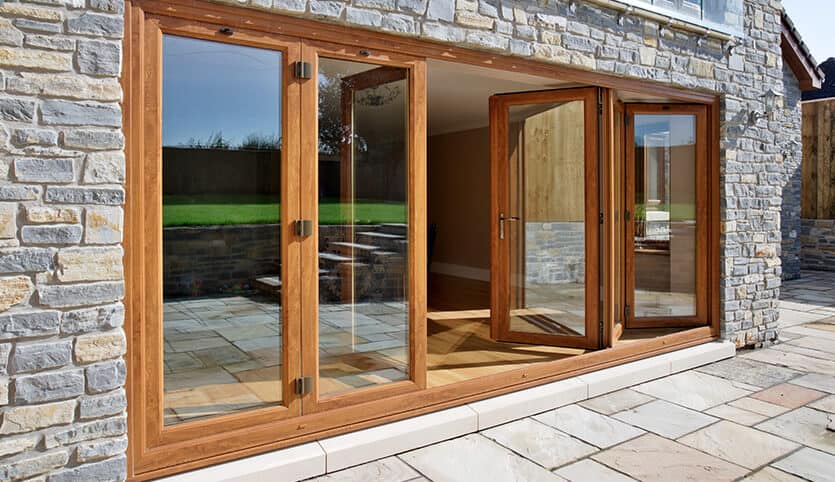 Eurocell oak-effect bi-fold doors creating an open-plan space